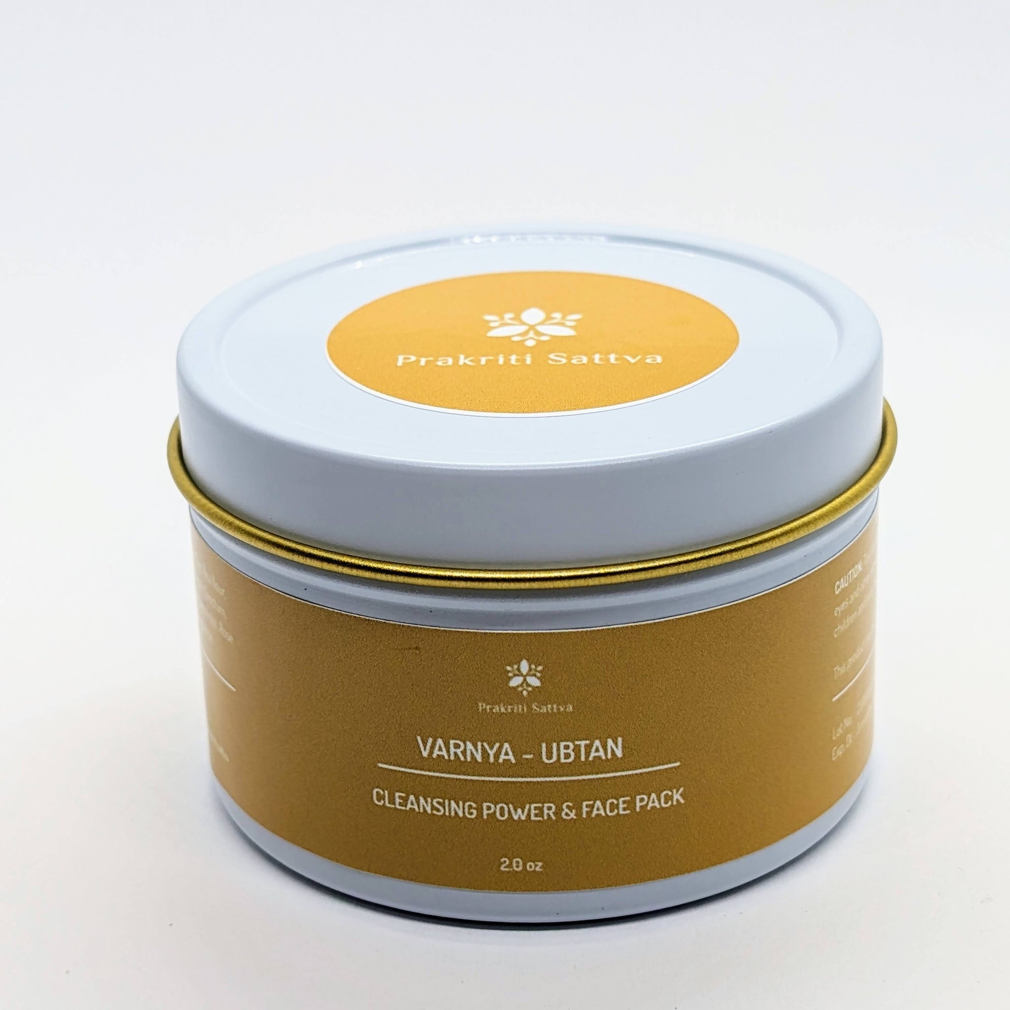 Prakriti Sattva Ayurvedic Ubtan Powder. A jar of orange-hued powder, perfect for natural face and body cleansing and scrubbing. The label features Ayurvedic herb powders like mung bean flour, besan / chickpea flour, rice flour, neem, licorice, rose, indicating the natural ingredients used.