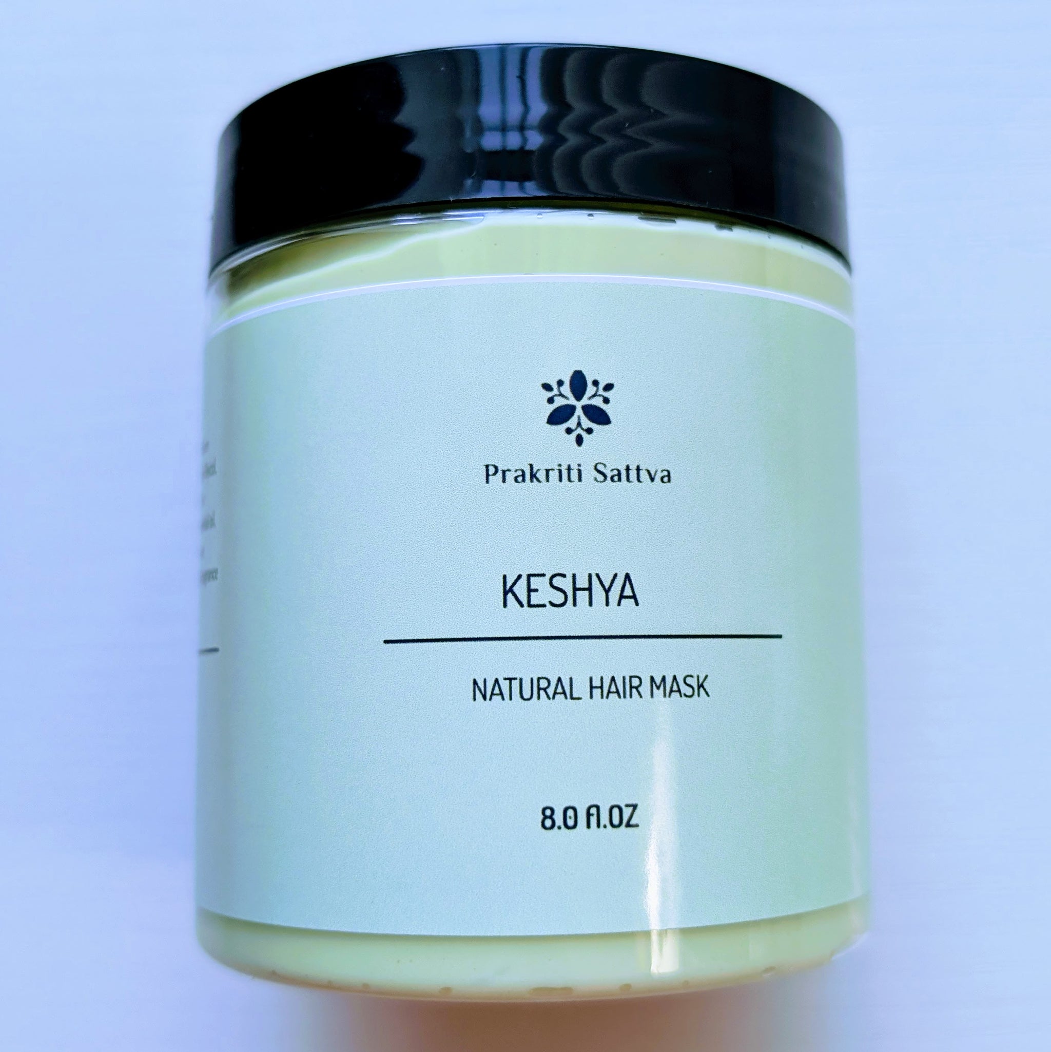 A 8-ounce jar of Prakriti Sattva Natural Deep Conditioning Hair Mask. The jar is filled with a creamy, green product.
