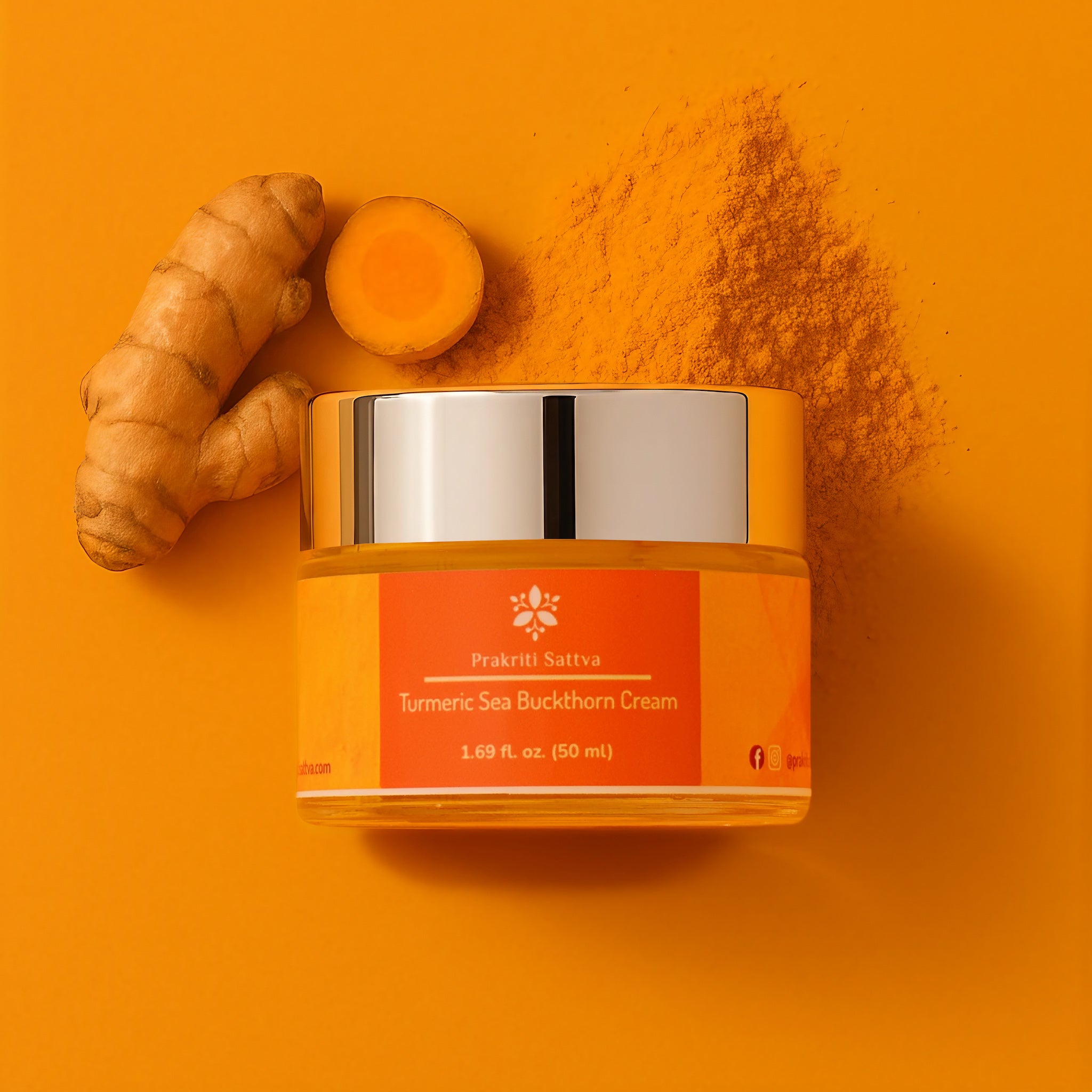 Orange Prakriti Sattva Turmeric Sea buckthorn cream jar with turmeric root and powder on an orange background