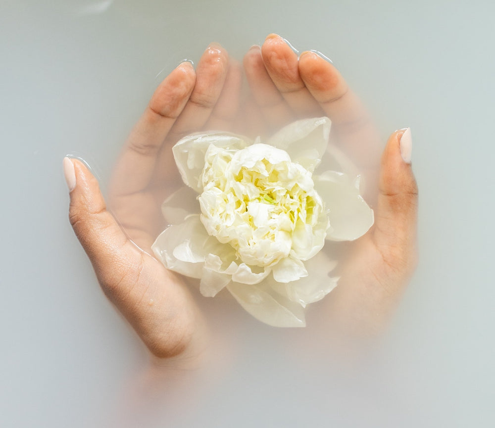 Natural flower in cupped hands - Prakriti Sattva Benefits of Natural Body Care products