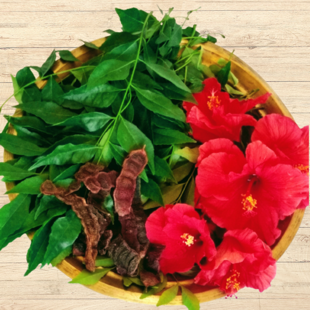 Hibiscus flowers, Neem leaves, Shikakai pods, Soapnut in a brass bowl for making Prakriti Sattva Ayurvedic Natural Shampoo Powder