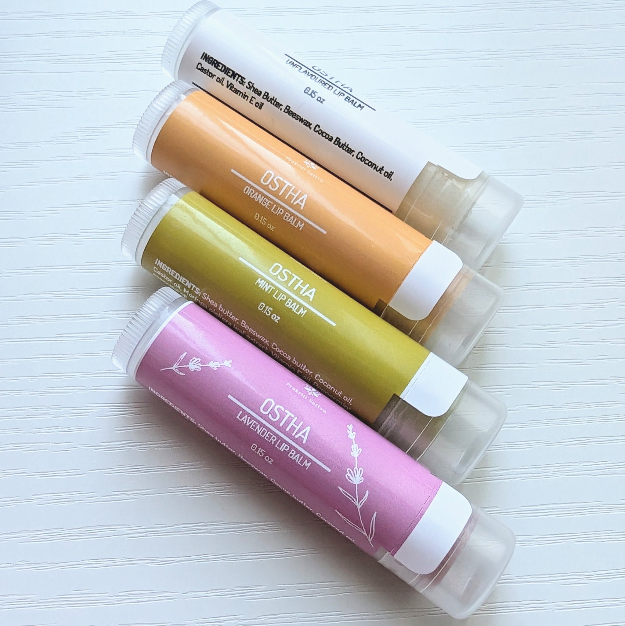 Ayurvedic natural lip balm with herbs infused for color. It is a tube of lip balm with a natural, earthy color. The label features Ayurvedic symbols and herbs, indicating the natural ingredients used.